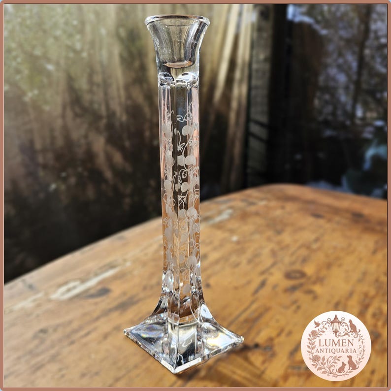 Pu&ograve; includere: Candelabro in vetro trasparente con design floreale inciso. Il candelabro ha una base quadrata, un lungo stelo rettangolare e una parte superiore svasata per una candela. Il motivo floreale &egrave; delicato e aggiunge eleganza.