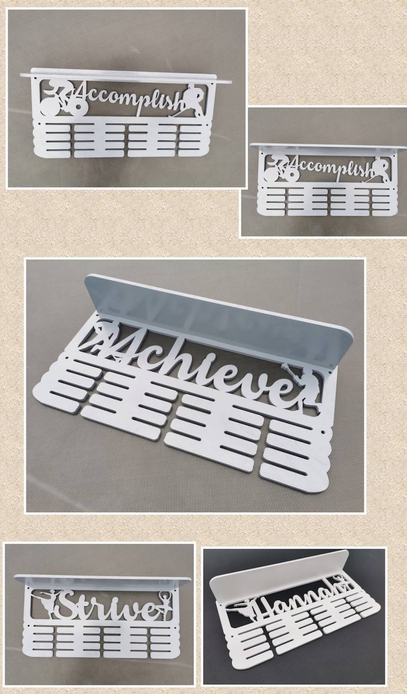 May include: White medal display rack with a shelf and 20 slots for medals. The rack features a cutout design with the word "Accomplish" and a figure of a person running.