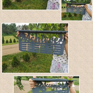 May include: A white wooden medal display with the name "Hannah" and a silhouette of a dancer. The display has 20 slots for medals.