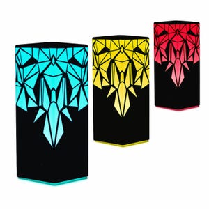 May include: Three geometric patterned lamps with black bases and colored light panels. The lamps are lit in blue, yellow, and red.
