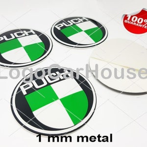 May include: Four round, black, white, and green metal stickers with the word "PUCH" in white. The stickers have a green and white checkered design. A red sticker with "100% GUARANTEE" is also visible. The text "1 mm metal" is at the bottom.