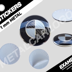 May include: Four 1 mm thick metal stickers featuring a black and white carbon fiber BMW logo. The stickers are shown on a white background with the text "4 STICKERS 1 mm METAL" in black.