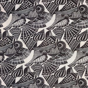 May include: Black and white repeating pattern featuring stylized seashell designs. The pattern includes various shell shapes, including spirals, fans, and elongated forms, all rendered in a detailed, graphic style. The background is a light cream color.