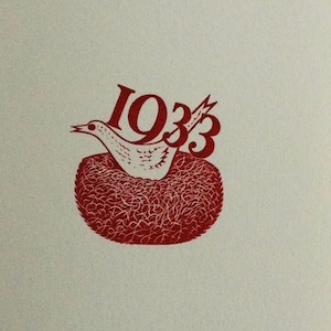 May include: Red illustration of a bird in a nest with the year 1933 printed above it.