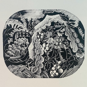 May include: Black and white woodcut print of a basket of grapes and leaves. The print is in a rounded oval shape.