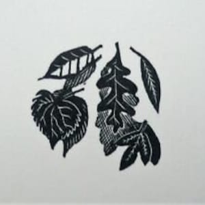 May include: Black and white print of five stylized leaves. The leaves are arranged in a cluster and have a variety of shapes and sizes.