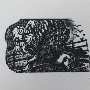 May include: Black and white woodcut print of a farm scene. A cow rests under a large tree next to a wooden fence. Birds fly in the sky above the tree. The print has a rustic, vintage feel.