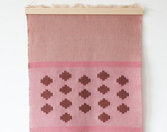 Minimalistic beige wall hanging with pink and brown motive