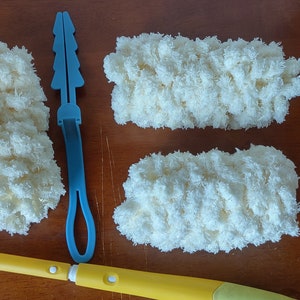 May include: A cleaning kit with a yellow and white extendable handle, a white plastic frame, and three fluffy, cream-colored cleaning pads. Also included is a blue plastic tool.