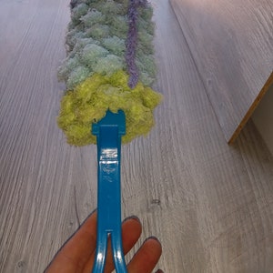 May include: A blue cleaning tool with a green, blue, and purple microfiber cleaning head.