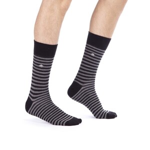 May include: A pair of black and gray striped socks. The socks have a small logo on the top.