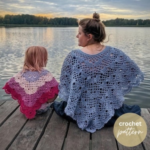 May include: Two triangular crochet shawls featuring a scalloped shell stitch pattern. One shawl is a solid light blue, while the other displays a gradient of purple, light pink, and deep magenta. The text crochet pattern is visible in the corner.