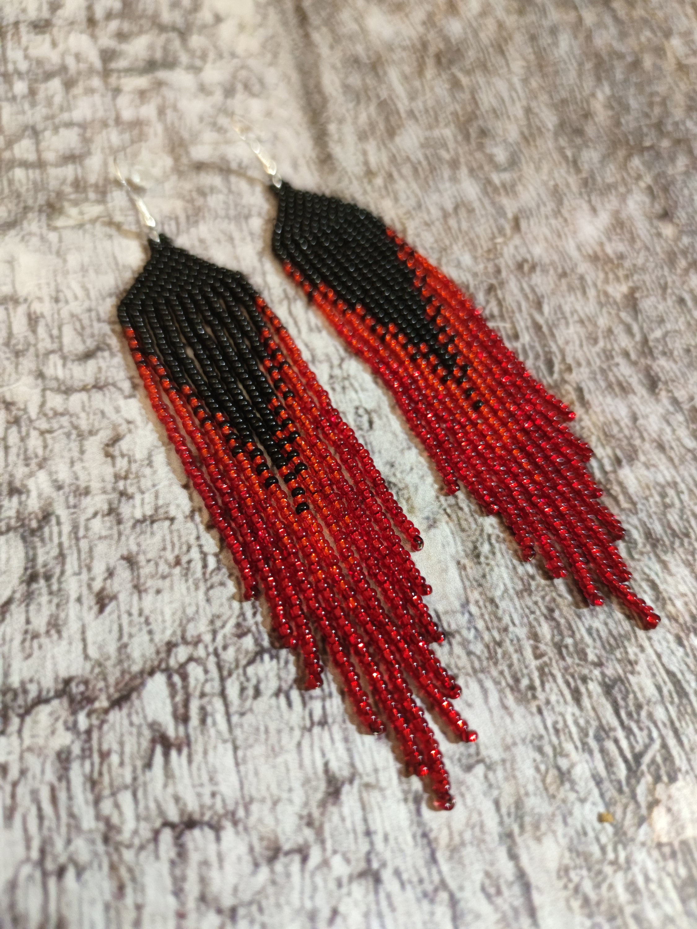 Red and black beaded earrings that dangle