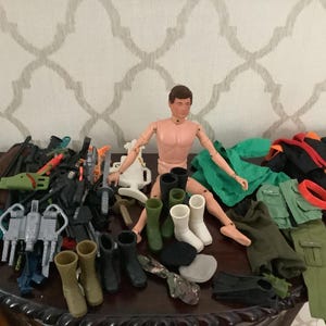 Vintage GI Joe Man of Action with lot of Clothes and Accessories