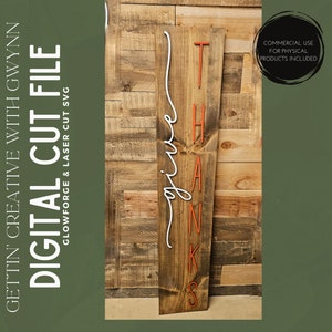 May include: A wooden sign with the word "thanks" in orange letters and the word "give" in white cursive lettering. The sign is on a wooden background.