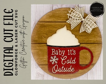 May include: A round wooden sign featuring a red mug with white whipped cream and the text "Baby it's Cold Outside". The mug is decorated with a snowflake. A brown and white bow is in the top right corner of the sign.