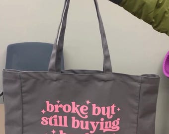 Broke but still buying books tote bag
