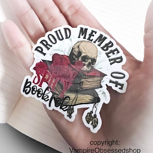 May include: A sticker with a skull and books, and the text "Proud Member of BookTok" and "Vampire Obsessed Shop".