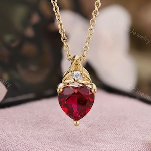 May include: A white ceramic mug with a black handle and the text "But First, Coffee" in a bold, black font. The mug is set against a blurred background, suggesting a cosy setting.