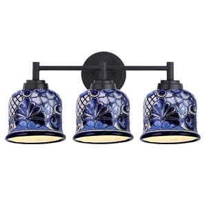 May include: A three-light vanity fixture with bell-shaped shades. The shades feature a blue and white floral design. The fixture has a black metal frame and mounting plate. The light fixture is designed for bathroom use.