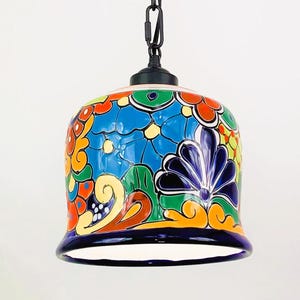 May include: A colorful ceramic pendant light with a blue, green, yellow, orange, and red floral pattern. The light fixture has a black chain and a black metal ceiling mount.