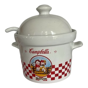 May include: White ceramic Campbell's soup bowl with lid and small handle. The bowl features a red and white checkered pattern and a circular graphic of two children. The word "SOUP" is printed at the bottom.