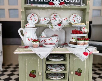 Farmhouse Cherry Theme Hutch, dishes, Christmas tray of goodies, candy canes, sign, silverware, and snowflakes! So Festive!!!!