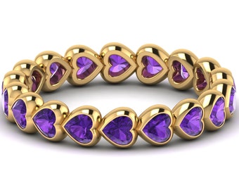 May include: A gold band ring with a row of heart-shaped amethyst gemstones.