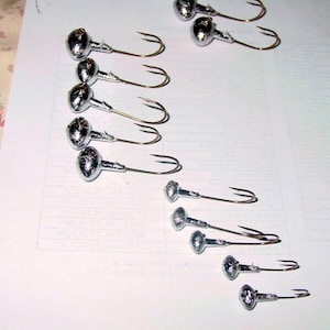 12 football jig heads to your order. 90-degree Eagle Claw hooks 1/16 to 1oz