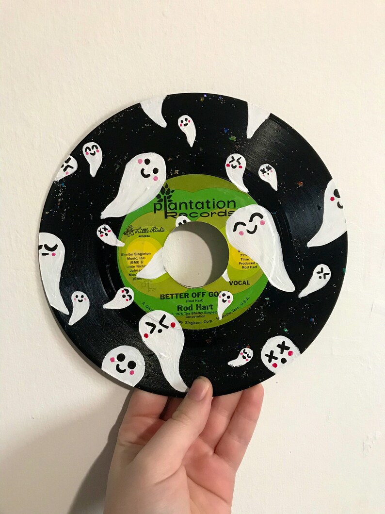 May include: A black vinyl record painted with white ghosts with pink cheeks and various facial expressions. The record label is green and white and says "Plantation Records" and "Better Off Gone" by Rod Hart.