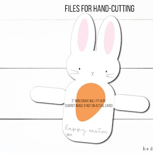 May include: Printable template for a hand-cut Easter bunny card. The bunny is white with pink ears and a peach-colored carrot. The card says "happy easter" and "2" mini cookie will fit here (carrot image is not on actual card).