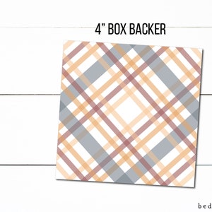May include: A 4-inch square box backer with a plaid pattern in shades of gray, orange, and burgundy. The design features intersecting diagonal lines, creating a classic plaid effect. The text "4" BOX BACKER" is at the top.