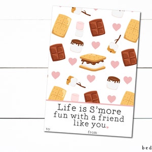 May include: A white card with a pattern of s'mores, chocolate bars, and marshmallows. The text on the card reads "Life is S'more fun with a friend like you." There are blank lines for "to" and "from".