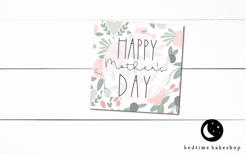 May include: A white card with a floral pattern and the text "Happy Mother's Day" in a circle.