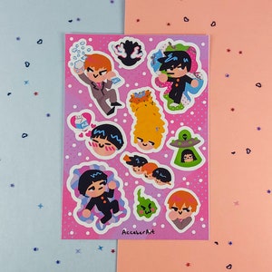 May include: A set of 10 colourful stickers featuring cartoon characters with different expressions. The stickers are on a pink background with white polka dots. The text "AcccberArt" is at the bottom of the sheet.
