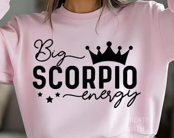 May include: A light pink sweatshirt with the words "Big Scorpio energy" in black script, a black crown, and three black stars. The text "CREATE WITH KAREN" is printed in white on the bottom right.