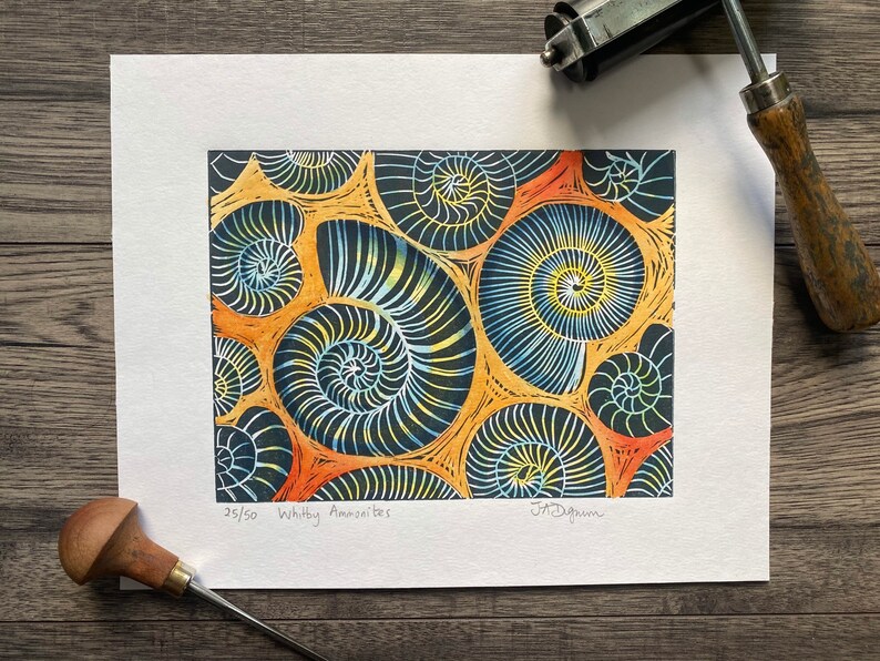 Whitby Ammonites Handmade,limited edition Linocut print Deep orange background.
