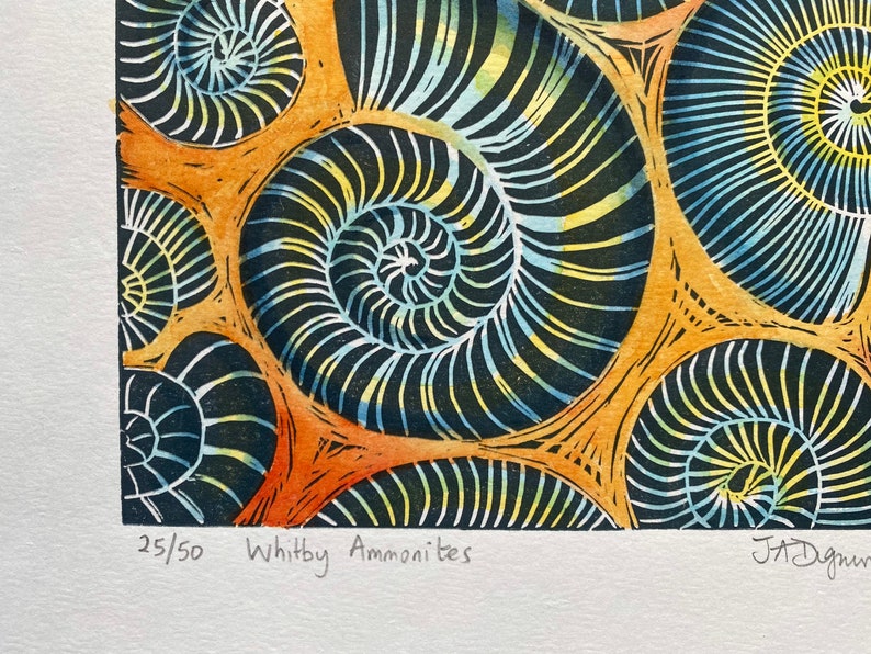 Whitby Ammonites Handmade,limited edition Linocut print Deep orange background.