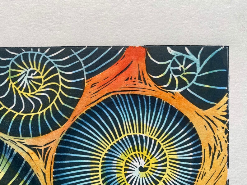 Whitby Ammonites Handmade,limited edition Linocut print Deep orange background.