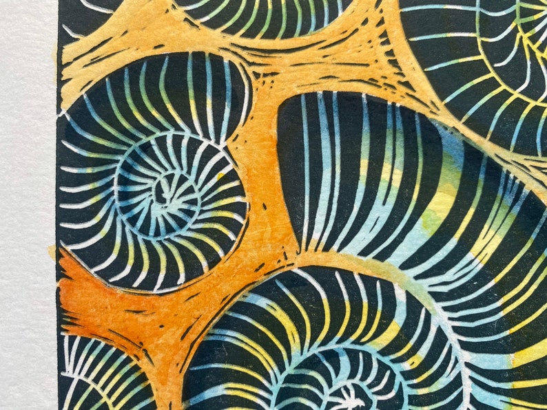 Whitby Ammonites Handmade,limited edition Linocut print Deep orange background.