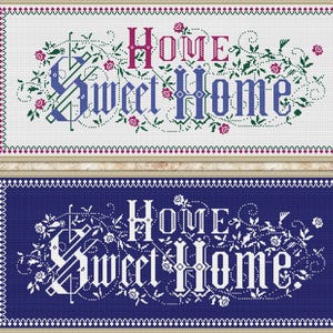 May include: Two framed cross-stitch pieces with the words "Home Sweet Home." One is on a white background with pink and green floral accents, the other on a navy blue background with white lettering and floral accents.