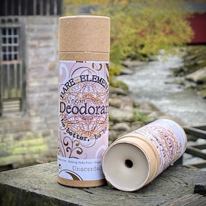 May include: Two brown cardboard tubes of unscented vegan deodorant. The label on the tube reads "Bare Elements Vegan Deodorant be better, be you. Aluminum Free, Baking Soda Free, Vegan. Unscented."