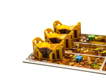 May include: A board game with a yellow honeycomb-shaped game piece and a blue bee game piece. The game board has a brown background with illustrations of bees and honeycombs.