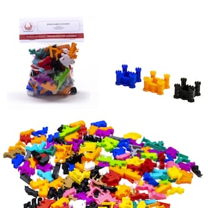 May include: A bag of colorful plastic game pieces, including castles, towers, and other shapes. The bag is labeled "Board Game Accessory".