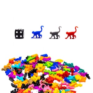 May include: A black die with white dots, a blue monkey, a gray monkey, and a red monkey. A large pile of colorful plastic monkeys in various poses.
