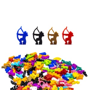 May include: A set of four plastic figurines of archers in blue, black, brown, and red. The figurines are holding bows and arrows and are standing on a white background. There is a pile of colourful plastic pieces in the bottom of the image.