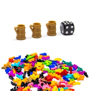 May include: A set of three brown ceramic mugs with a black dice. A large pile of colourful plastic game pieces in various shapes and sizes.