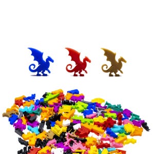 May include: A pile of colourful plastic dragon figurines, including a blue, red, and brown dragon. The dragons are all facing the right side of the image.