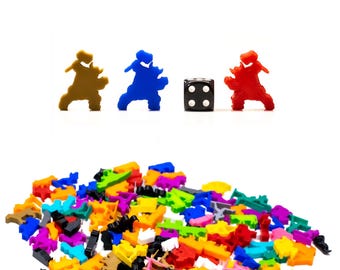 May include: A pile of colourful plastic game pieces, including brown, blue, red, and yellow. A single black die with white dots is in the centre of the image.