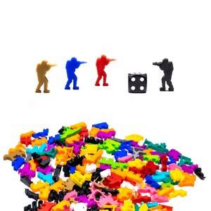 May include: A set of colorful plastic game pieces, including four figures holding guns and a black die with four dots. The figures are in blue, red, brown, and black. The pieces are scattered on a white surface.